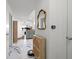 Hallway featuring marble floors, cabinet, mirror and an open view of the kitchen and living room at 2410 W Azeele St # 214, Tampa, FL 33609