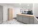 Kitchen featuring gray cabinets, butcher block island, marble flooring, and opening to the living room at 2410 W Azeele St # 214, Tampa, FL 33609