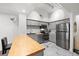 Bright kitchen featuring stainless steel appliances, gray cabinets, butcher block island, and marble flooring at 2410 W Azeele St # 214, Tampa, FL 33609
