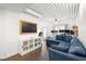 Cozy living room featuring a blue velvet sectional sofa, hardwood floors, and natural light at 2410 W Azeele St # 214, Tampa, FL 33609
