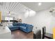 Living room area with blue velvet sectional sofa, desk, and hardwood flooring at 2410 W Azeele St # 214, Tampa, FL 33609