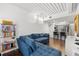 Open-concept living room features a blue sectional sofa and a view of the kitchen with bar seating at 2410 W Azeele St # 214, Tampa, FL 33609