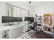 Home office area with dual monitors, modern desk, and shelving with books at 2410 W Azeele St # 214, Tampa, FL 33609