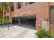 Secured parking entrance with gate, signage, and lush greenery, ensuring privacy and property access for residents at 2410 W Azeele St # 214, Tampa, FL 33609