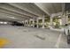 Brightly lit parking garage with numbered parking spaces, providing secure and convenient parking for residents at 2410 W Azeele St # 214, Tampa, FL 33609