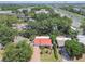 Aerial view of a neighborhood with tree-lined streets, showing proximity to a main highway and commercial areas at 2484 Whitman St, Clearwater, FL 33765