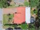 Aerial view of the home highlighting the red roof, brick driveway, and mature trees at 2484 Whitman St, Clearwater, FL 33765