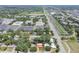 Wide aerial view of residential area near commercial buildings, parking, athletic fields, and highway at 2484 Whitman St, Clearwater, FL 33765