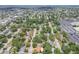 Extensive aerial view reveals a densely populated residential neighborhood with tree-lined streets and nearby amenities at 2484 Whitman St, Clearwater, FL 33765