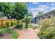 Beautiful backyard featuring lush landscaping, brick paths and screened patio at 2484 Whitman St, Clearwater, FL 33765