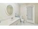 Clean bathroom with white vanity, oval mirror, and tiled floors at 2484 Whitman St, Clearwater, FL 33765