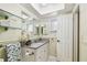 Bright bathroom with granite countertop, undermount sink, and glass shelves at 2484 Whitman St, Clearwater, FL 33765