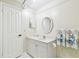 Well-lit bathroom features a vanity with storage and framed mirror at 2484 Whitman St, Clearwater, FL 33765
