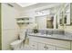 Bathroom featuring granite counters, stylish cabinets, and modern fixtures at 2484 Whitman St, Clearwater, FL 33765