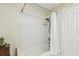 Full bathroom features white-tiled shower-tub combo and classic fixtures at 2484 Whitman St, Clearwater, FL 33765