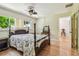 Bedroom features a four-poster bed, hardwood floors and bright natural light at 2484 Whitman St, Clearwater, FL 33765