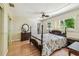 Comfortable bedroom with hardwood floors, a four-poster bed, and natural light at 2484 Whitman St, Clearwater, FL 33765