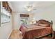 Cozy bedroom with hardwood floors, ceiling fan, and a bright window at 2484 Whitman St, Clearwater, FL 33765
