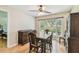 Dining room boasts hardwood floors, a ceiling fan, and a window with a backyard view at 2484 Whitman St, Clearwater, FL 33765