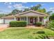 Inviting single-story home with brick walkway, red shutters, and well-manicured lawn at 2484 Whitman St, Clearwater, FL 33765