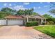 Charming single-story home with a red tile roof, brick driveway, and a well-manicured front yard at 2484 Whitman St, Clearwater, FL 33765