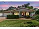 Charming single-story home with brick walkway, red shutters, and lush landscaping at 2484 Whitman St, Clearwater, FL 33765