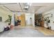 Spacious garage area featuring tile flooring, laundry hookups and storage at 2484 Whitman St, Clearwater, FL 33765