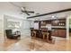 Spacious kitchen featuring dark wood cabinets, a center island with seating, and hardwood floors at 2484 Whitman St, Clearwater, FL 33765