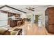 Open-concept kitchen with a center island, wooden bar stools, and hardwood floors at 2484 Whitman St, Clearwater, FL 33765