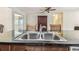 Well-lit kitchen boasts granite countertops, a double sink, and a view into the living area at 2484 Whitman St, Clearwater, FL 33765