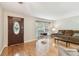 Bright living room boasts hardwood floors, a decorative front door, and a large window at 2484 Whitman St, Clearwater, FL 33765