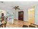 Open-concept living area showcases hardwood floors, a ceiling fan, and a classic armoire at 2484 Whitman St, Clearwater, FL 33765