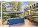 Enclosed patio with a hot tub, shaded area, and brick floor at 2484 Whitman St, Clearwater, FL 33765