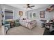 Bright bedroom features a ceiling fan, two windows, a bed and a desk at 2781 Dolores Home Ave, Valrico, FL 33594