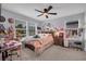 Bright bedroom features a ceiling fan, two windows, a bed and a desk at 2781 Dolores Home Ave, Valrico, FL 33594