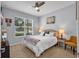 Cozy bedroom with a queen size bed, plush carpeting, and a bright window at 2781 Dolores Home Ave, Valrico, FL 33594