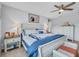 Bright bedroom features a ceiling fan, end tables with lamps, and a chest of drawers at 2781 Dolores Home Ave, Valrico, FL 33594