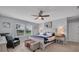 Bright bedroom features a ceiling fan, large window, and an upholstered storage bench at the end of the bed at 2781 Dolores Home Ave, Valrico, FL 33594