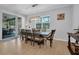 Inviting dining room with modern light fixtures, sliding glass doors, and hardwood flooring at 2781 Dolores Home Ave, Valrico, FL 33594