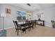 Stylish dining area showcasing a modern light fixture and an elegant hardwood floor at 2781 Dolores Home Ave, Valrico, FL 33594