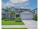 Charming two-story home with well-manicured lawn, complemented by a neatly paved driveway and two-car garage at 2781 Dolores Home Ave, Valrico, FL 33594