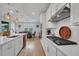 This modern kitchen features white cabinets, quartz countertops, and stainless steel appliances at 2781 Dolores Home Ave, Valrico, FL 33594
