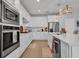 Charming kitchen boasts stainless steel appliances, sleek quartz countertops, and ample cabinet space at 2781 Dolores Home Ave, Valrico, FL 33594