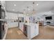 Bright, open kitchen features white cabinets, stainless steel appliances, and a large island at 2781 Dolores Home Ave, Valrico, FL 33594
