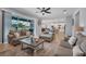 Inviting living room with a view of the kitchen, showcasing hardwood flooring and neutral decor at 2781 Dolores Home Ave, Valrico, FL 33594