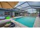 Private pool featuring ample seating, backyard views, and an umbrella for shade at 2781 Dolores Home Ave, Valrico, FL 33594