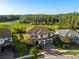 Aerial view of a luxurious home with a tile roof, backing to a private green space at 28512 Picana Ln, Wesley Chapel, FL 33543
