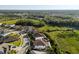 Drone view of a suburban neighborhood nestled amongst a thick green forest at 28512 Picana Ln, Wesley Chapel, FL 33543