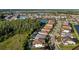 Aerial view of a residential neighborhood with lakes and lush green forests at 28512 Picana Ln, Wesley Chapel, FL 33543
