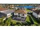Aerial view of backyard pool with hot tub, overlooking a serene neighborhood lake at 28512 Picana Ln, Wesley Chapel, FL 33543